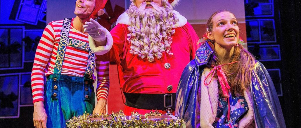 Production shot of The Santa Claus Show, featuring actors in costumes as Elfie, Santa, and young Alanah.